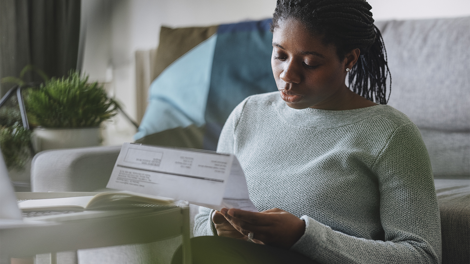 woman going over utility bill at home   